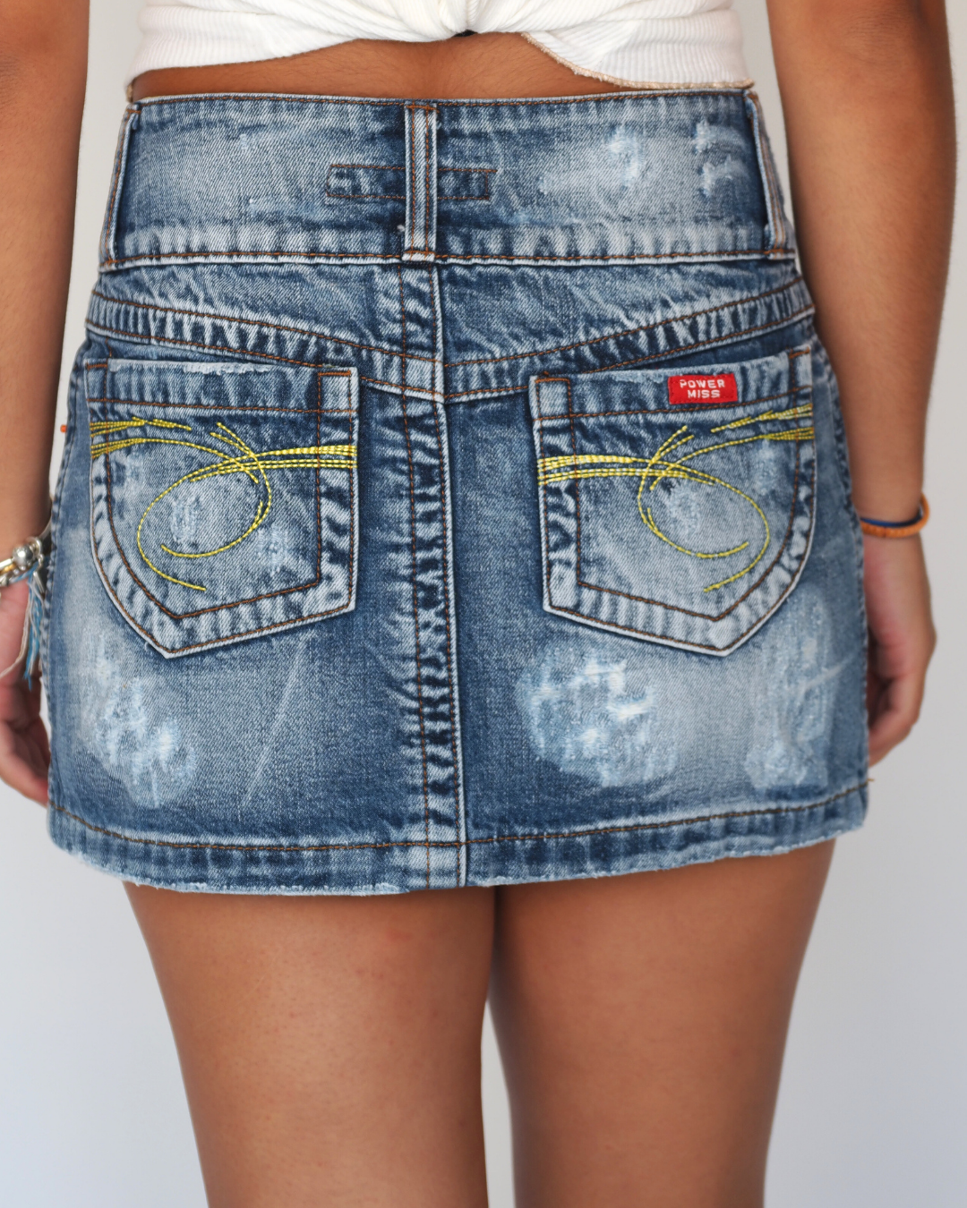 Power Miss Distressed Low-Rise Denim Mini Skirt with Embroidered Yellow Pocket Detail