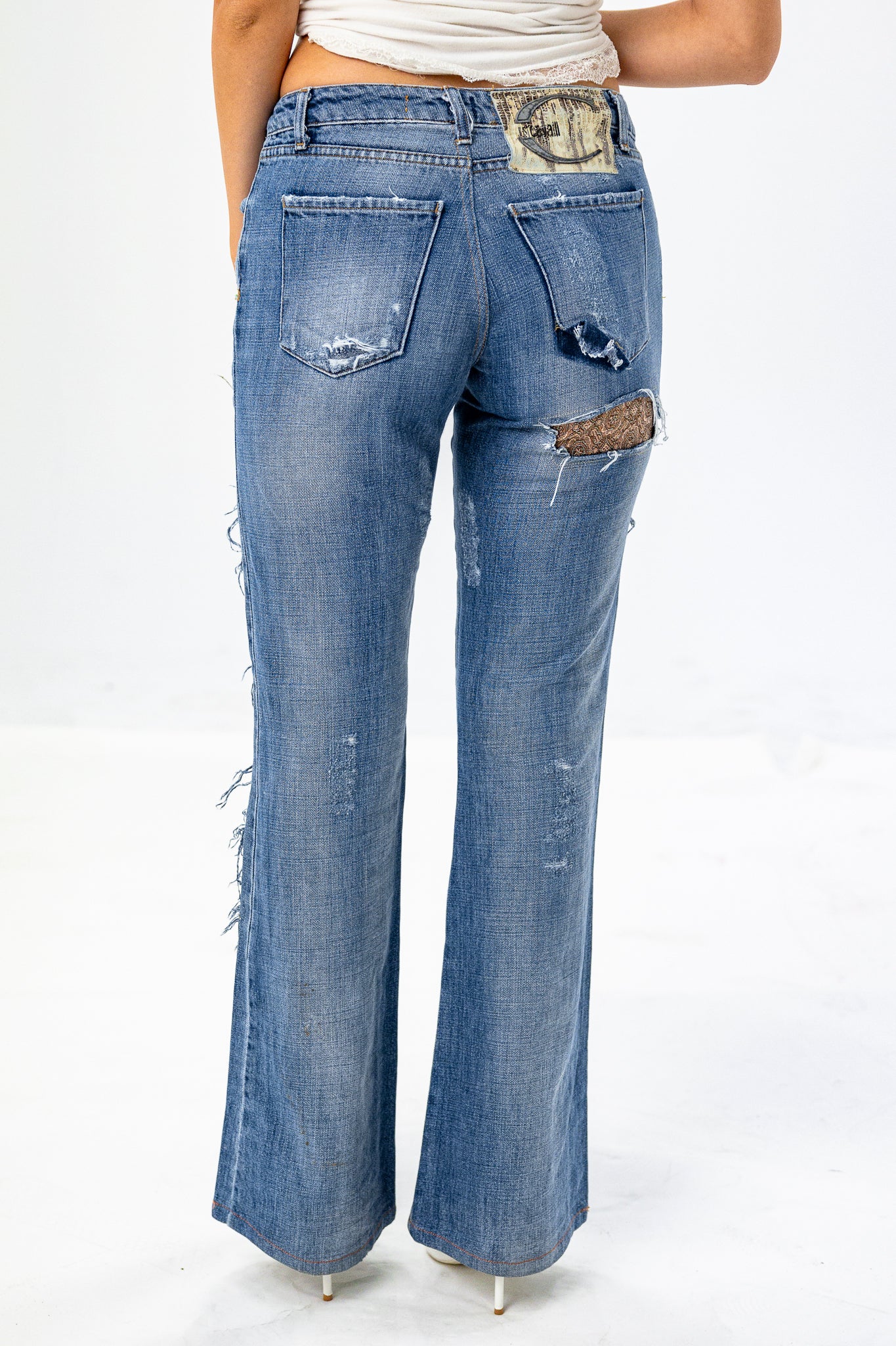 Low-Rise Ripped Jeans with Cut-out detail under Cheek